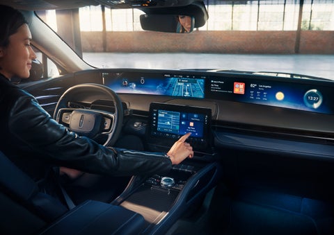 The driver of a 2024 Lincoln Nautilus® SUV interacts with the center touchscreen. | Dave Sinclair Lincoln in St Louis MO